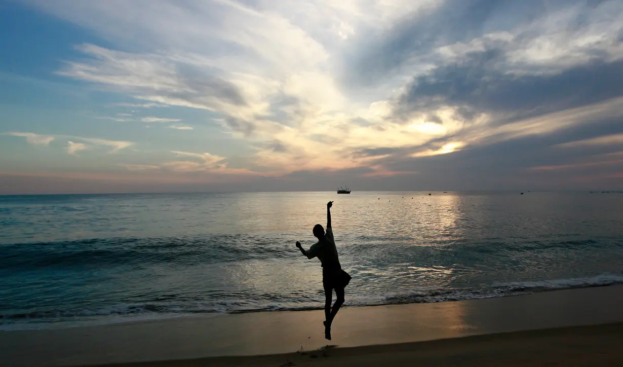 A fisherman throws his line in the morning in Arugam Bay, east of Colombo