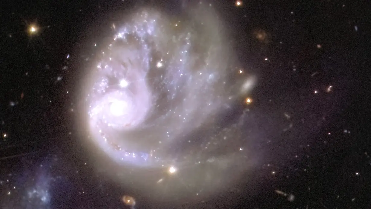 The spiral structure of a galaxy within the galactic cluster Abell 3381 can be seen within the mosaic when zoomed in 150 times.