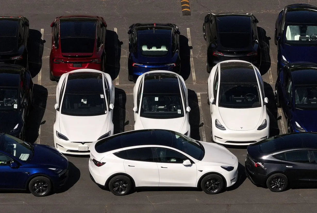 In an aerial view, brand new Tesla cars sit parked at a Tesla dealership in Corte Madera, California.