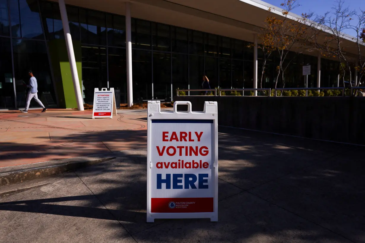 A sign sits outside of a polling location as the battleground state opened for early voting, in Atlanta