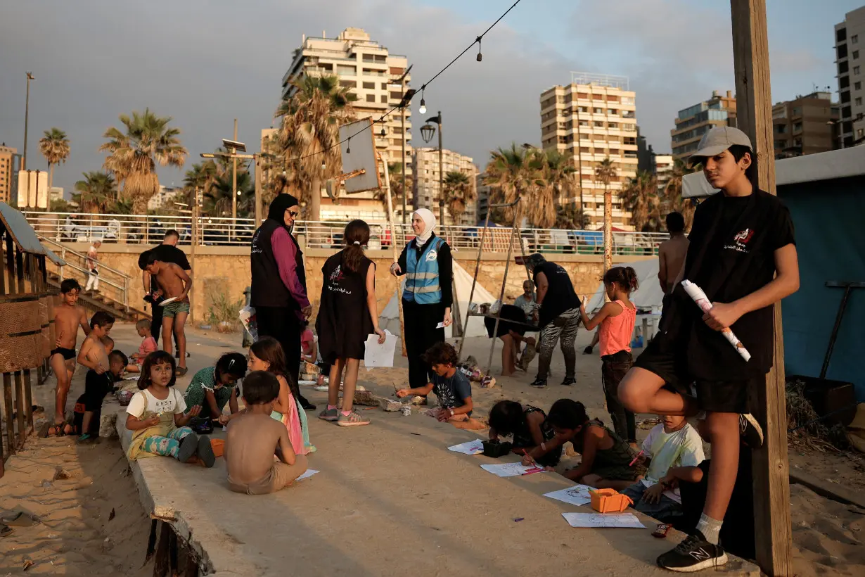 FILE PHOTO: Displaced children on a Beirut beach get creative though painting with the help of volunteers