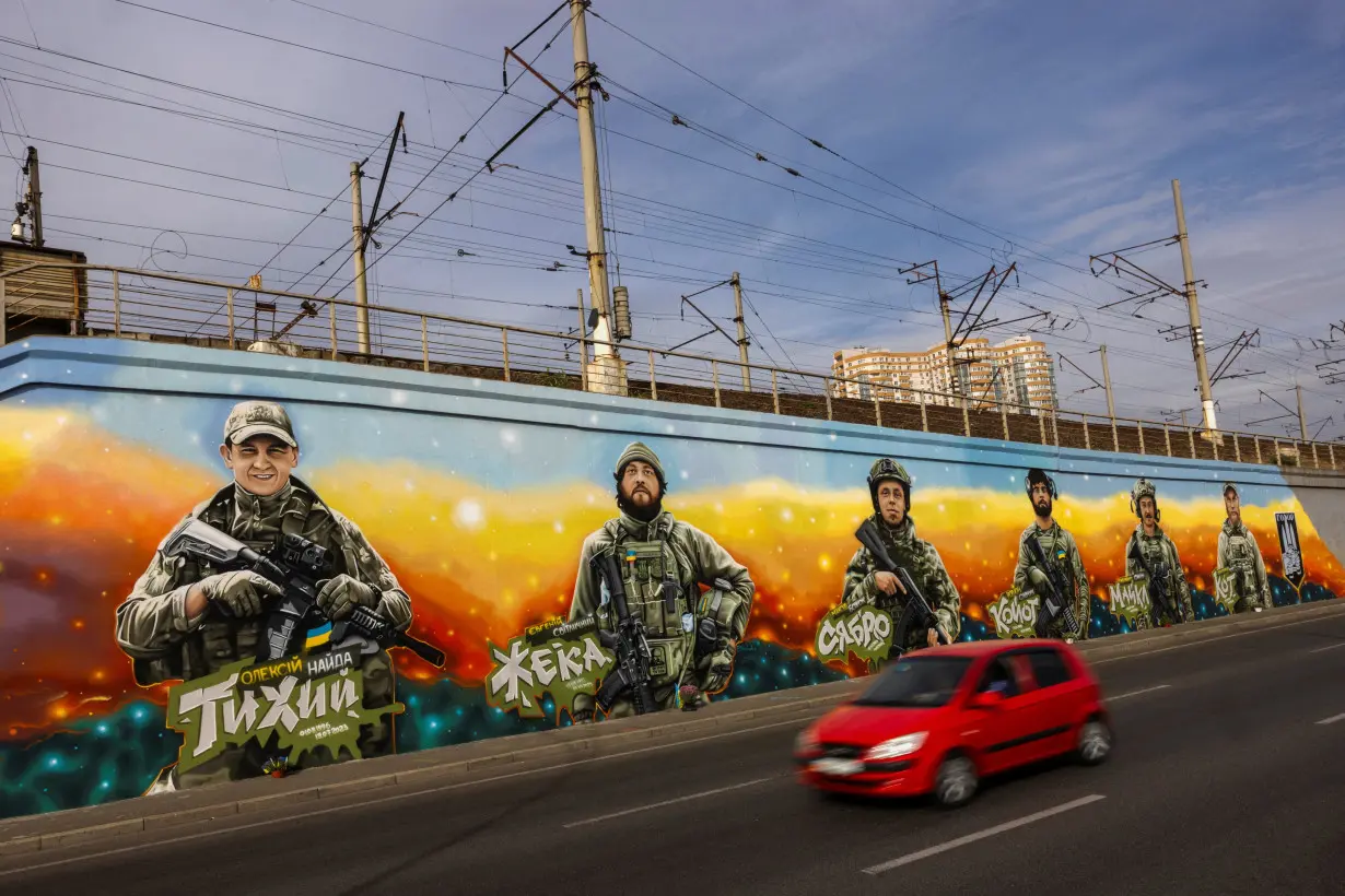 Ukrainian street artist honors fallen Ukrainian soldiers with giant murals in Kyiv