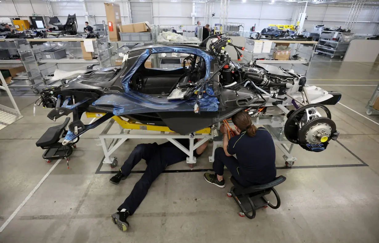 FILE PHOTO: Employees work on an Aston Martin Valkyrie car at the company's factory in Gaydon