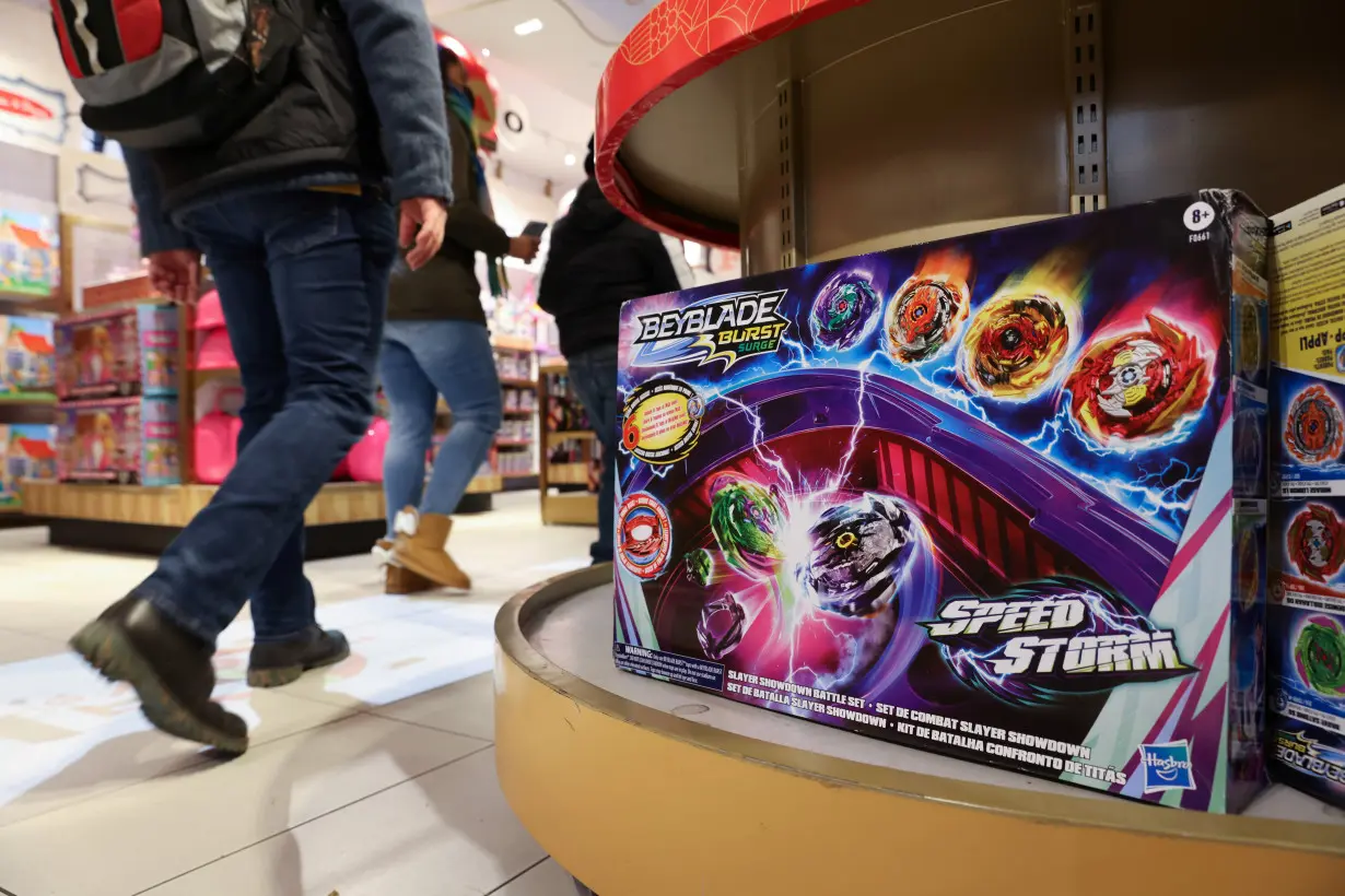 People walk past the Beyblade Burst Speedstorm, by Hasbro, Inc., on display in the FAO Schwarz toy store in Manhattan, New York City