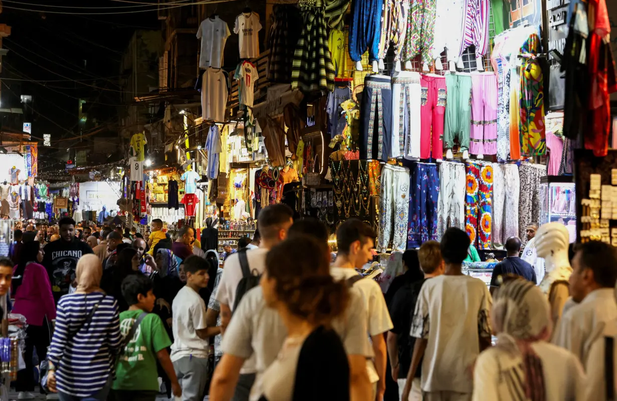 People walk through the Khan el-Khalili popular tourist market in old Cairo