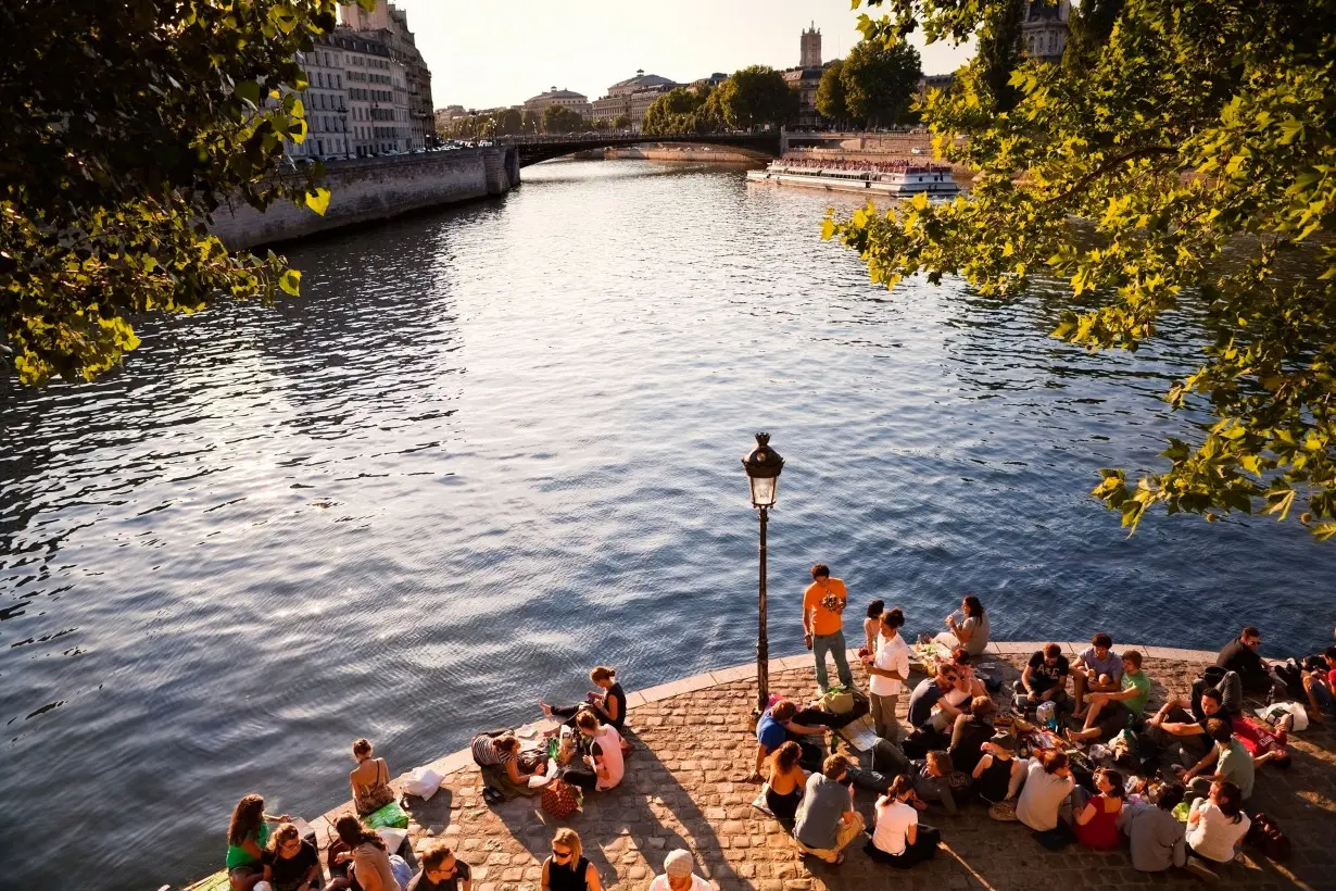 Word choices matter in any language. Young people gather here along the River Seine in Paris.