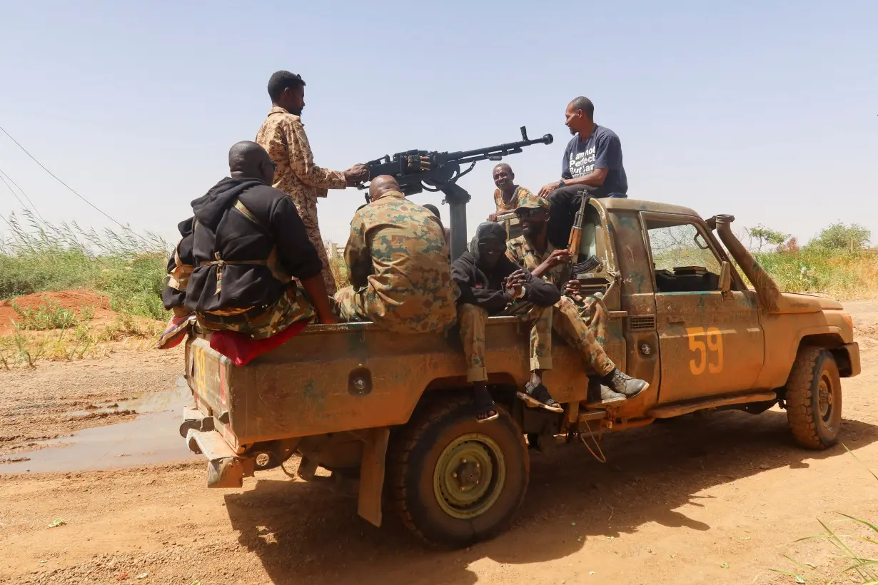 FILE PHOTO: Members of Sudanese armed forces sit on an army vehicle in Omdurman