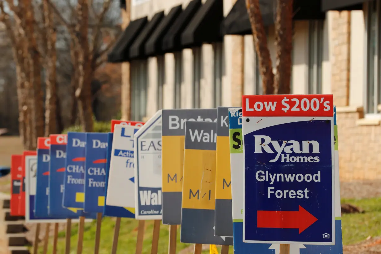 Real estate signs advertise new homes for sale in multiple new developments in York County, South Carolina