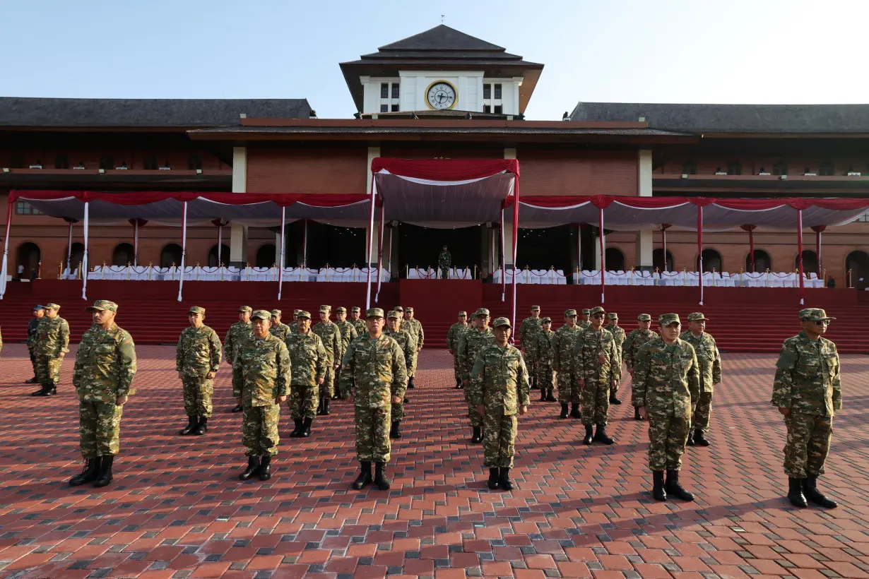 Newly appointed cabinet ministers stand during the retreat at a military academy in Magelang