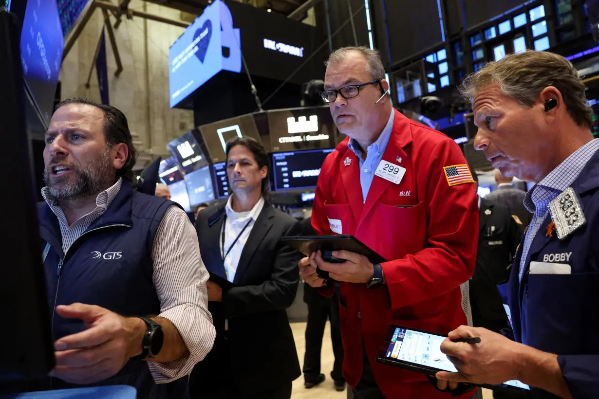 Traders work on the floor of the NYSE in New York