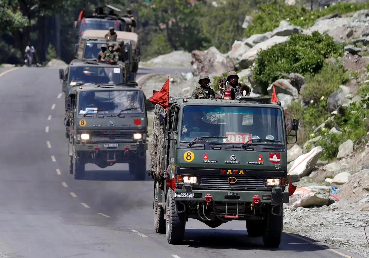 Indian Army convoy moves along a highway leading to Ladakh, at Gagangeer