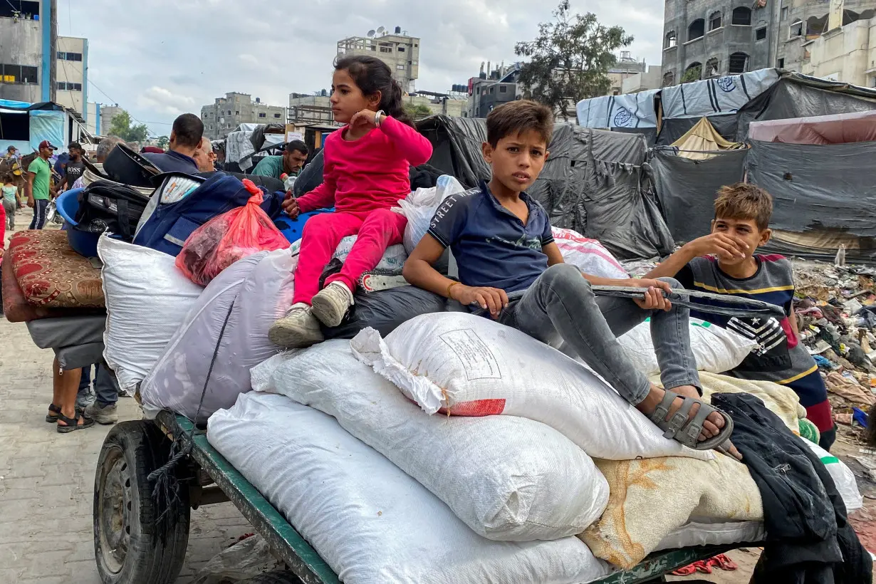 Displaced Palestinians flee areas in northern Gaza Strip following an Israeli evacuation order, in Gaza