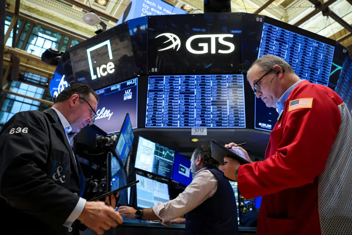 Traders work on the floor of the NYSE in New York