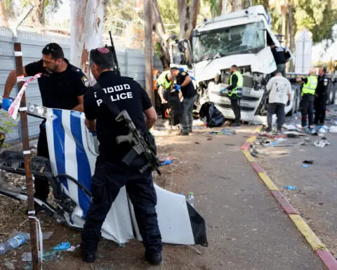 One killed, dozens injured in truck ramming at Israeli bus stop