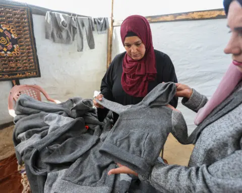 Displaced Gazans sew winter clothes from blankets