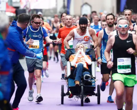 Colin Farrell finishes Dublin Marathon while pushing friend in a wheelchair