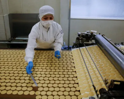 Japan continues to see moderate economic recovery, cuts factory output view