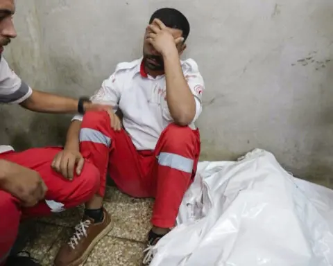 A Gaza medic realizes he's carrying his own mother's body, killed by an Israeli airstrike