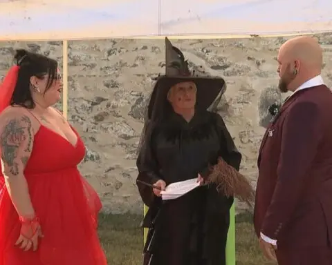 "It's showtime" for New Jersey couple who channel Beetlejuice and Lydia for Halloween wedding