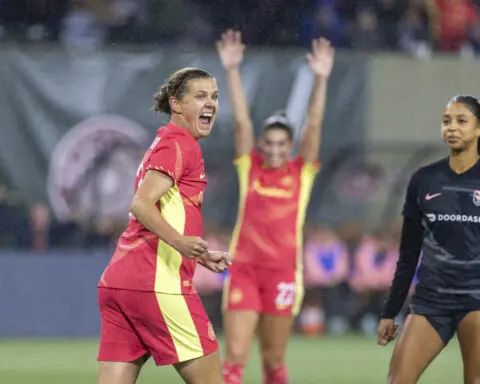 Sinclair scores in retirement match, Thorns down Angel City 3-0 to clinch playoff spot before 23,000