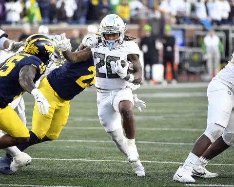 Dillon Gabriel throws a TD pass and runs for a score to lead No. 1 Oregon to 38-17 win over Michigan