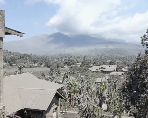 Indonesian rescuers dig through volcanic ash after eruption kills 9 and destroys buildings