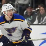 Blues' Dylan Holloway escapes serious injury after being struck in neck by puck