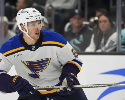 Blues' Dylan Holloway escapes serious injury after being struck in neck by puck