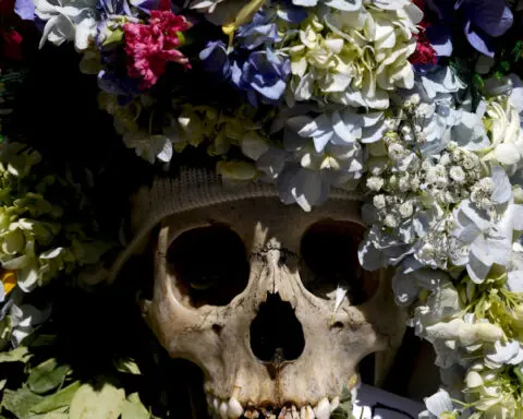 Bolivians carry adorned human skulls asking for favors in the Ñatitas festival in La Paz