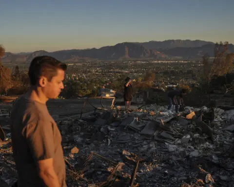 Firefighters advance on destructive blaze in California, aided by slower winds