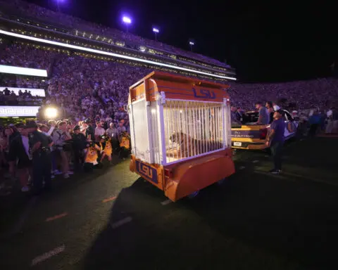 Caged tiger wheeled into LSU's Tiger Stadium for the first time since 2015 at governor's behest