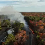 A man has been charged with arson in connection to a New Jersey wildfire sparked by a shotgun round, officials say