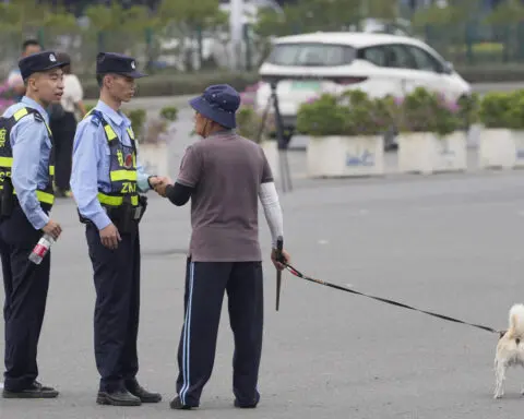 Silence descends around China’s deadliest mass killing in years as flowers cleared away