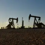 Oil prices edge down, forecasts for higher oil output, weak demand growth weigh