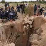 Families gather at South African mine shaft where hundreds are feared underground