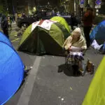 Protesters in Georgia's capital set up a tent camp on the main street and call for new elections