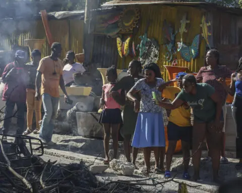 Residents in Haiti's capital stand with police in a battle to repel the latest gang attack