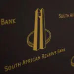 South African central bank trims key rate but stresses tough backdrop