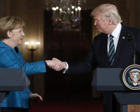 German ex-leader Merkel says she felt sorrow at Trump's comeback and recalls awkward non-handshake