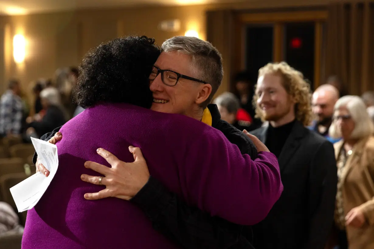 Vienna Cavazos hugs Rev. Cathy Rion Starr following the remembrance event. Cavazos praised the trans community's resilience. 