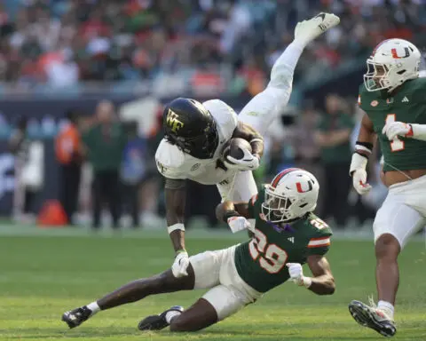 No. 11 Miami pulls away late to beat Wake Forest 42-14 and move one win from the ACC title game