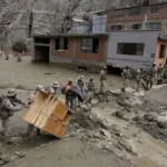 Heavy rains in Bolivia send mud crashing into the capital, leaving 1 missing and destroying homes