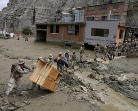 Heavy rains in Bolivia send mud crashing into the capital, leaving 1 missing and destroying homes