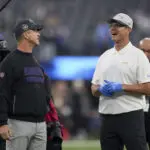 Harbaugh brothers share hug at midfield before facing each other for 3rd time