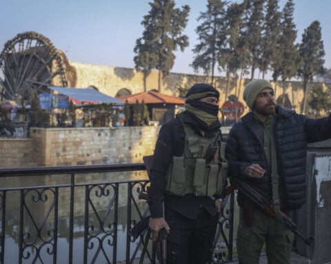 Thousands flee as Syrian insurgents advance to the doorstep of the country's third-largest city