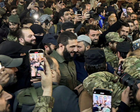 Syrian rebel leader says he will dissolve toppled regime forces, close prisons