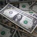 Dollar holds steady despite rate cut bets; Aussie rises after jobs data