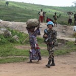 UN peacekeepers guard Congolese farmers working their fields