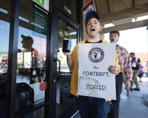 Starbucks workers begin strikes that could spread to hundreds of US stores by Christmas Eve