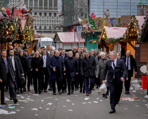 Germans mourn the 5 killed and 200 injured in the apparent attack on a Christmas market